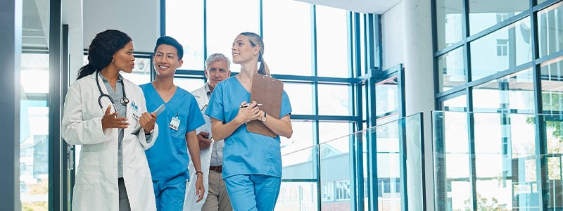 doctors and nurses walking in a hallway together